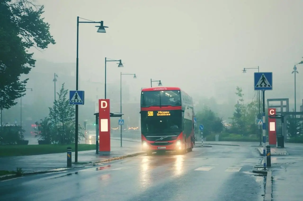 Double-decker bus in fog at Jönköping, Sweden bus stop.