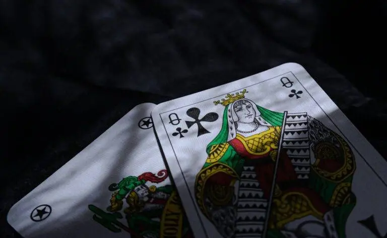 A close-up of two playing cards under dramatic lighting, emphasizing chance and mystery.