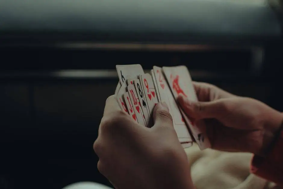 Close-up of hands playing cards. A classic game setting with a cozy atmosphere.