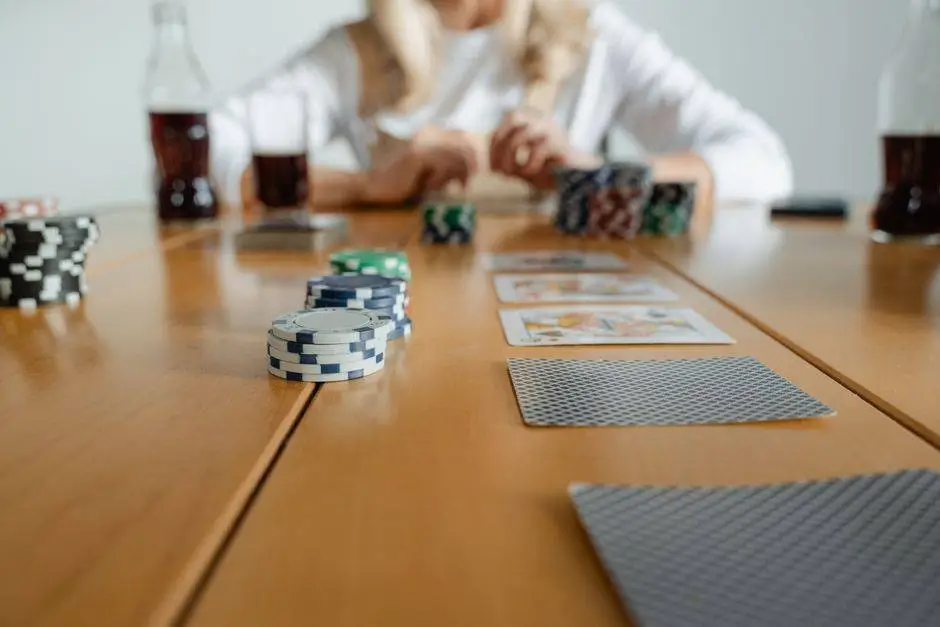 Close-up of poker chips and cards on a table during a casual game session indoors.